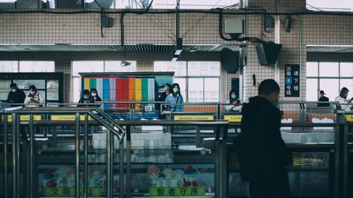 Free Masked commuters at a Shanghai metro station during the day. Stock Photo