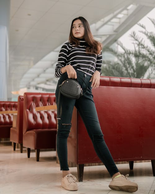 Free Woman In Black And White Striped Long Sleeve Shirt And Denim Jeans  Stock Photo