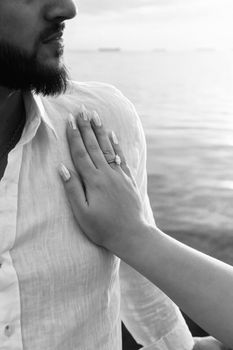 A romantic black and white close-up at the seaside in Baku, highlighting a couple's intimate moment.