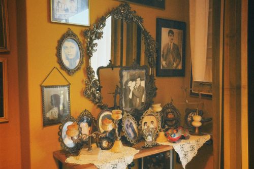 Free A collection of vintage portraits and frames on a table with ornate decorations. Stock Photo