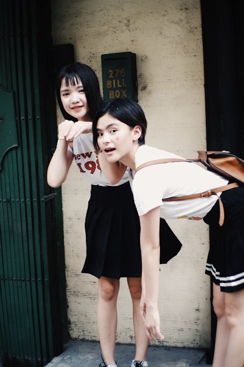 Women In White Shirt And Black Skirt