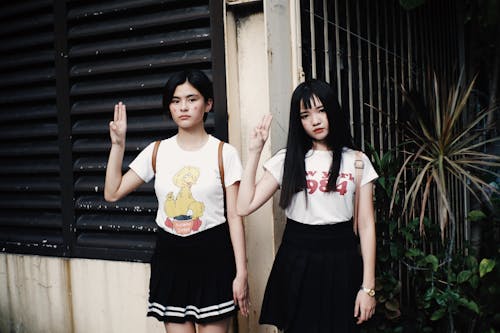 Free 2 Women Standing Beside A Wall Stock Photo