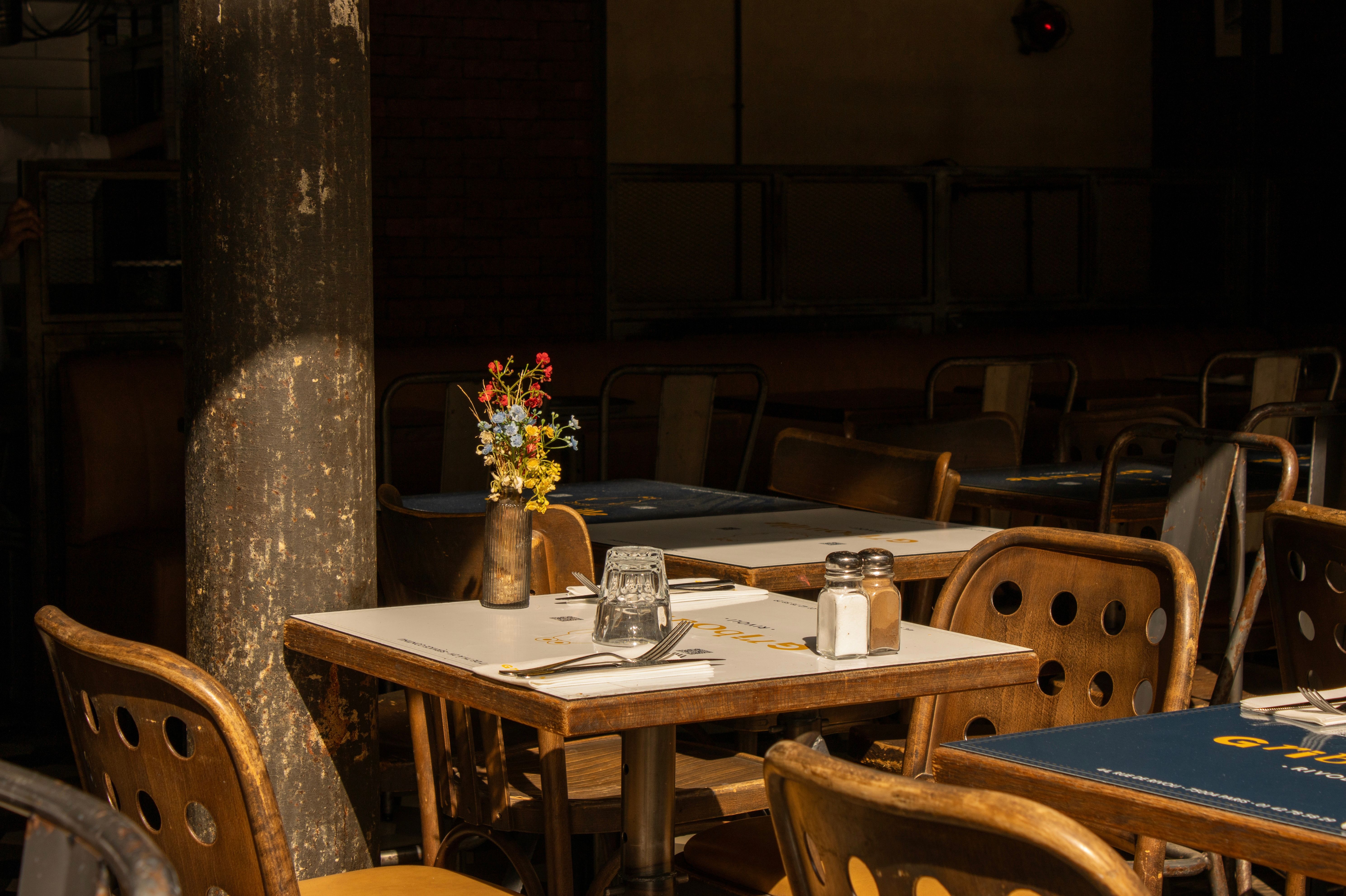 Charming cafe table setting in warm light, perfect for a cozy dining experience.