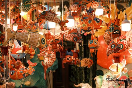 Free Colorful fish lanterns hang beautifully in a vibrant festive atmosphere. Stock Photo