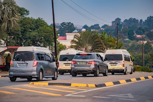 Free A street view in Malkerns, Eswatini with multiple cars and vans on the road. Stock Photo