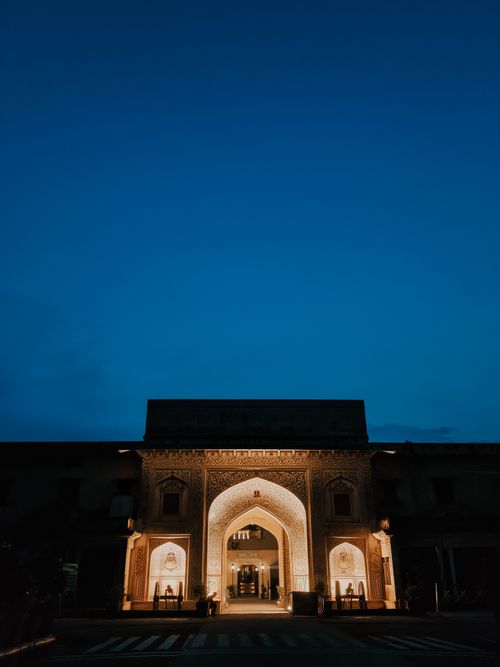 Free Stunning lit archway of historic architecture against a deep blue night sky, depicting cultural heritage. Stock Photo