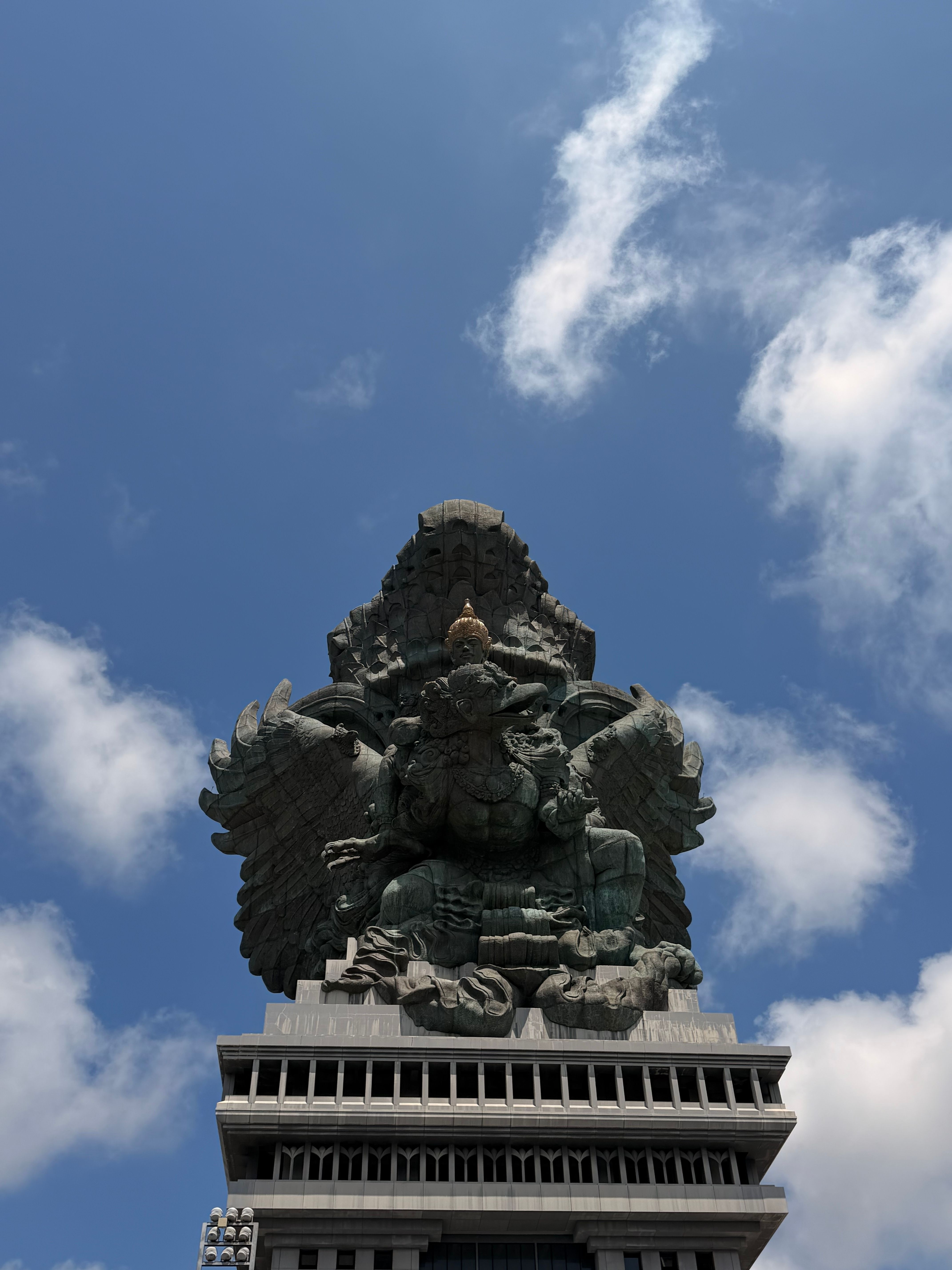 Stunning view of Garuda Wisnu Kencana statue under a clear sky in Bali, Indonesia.