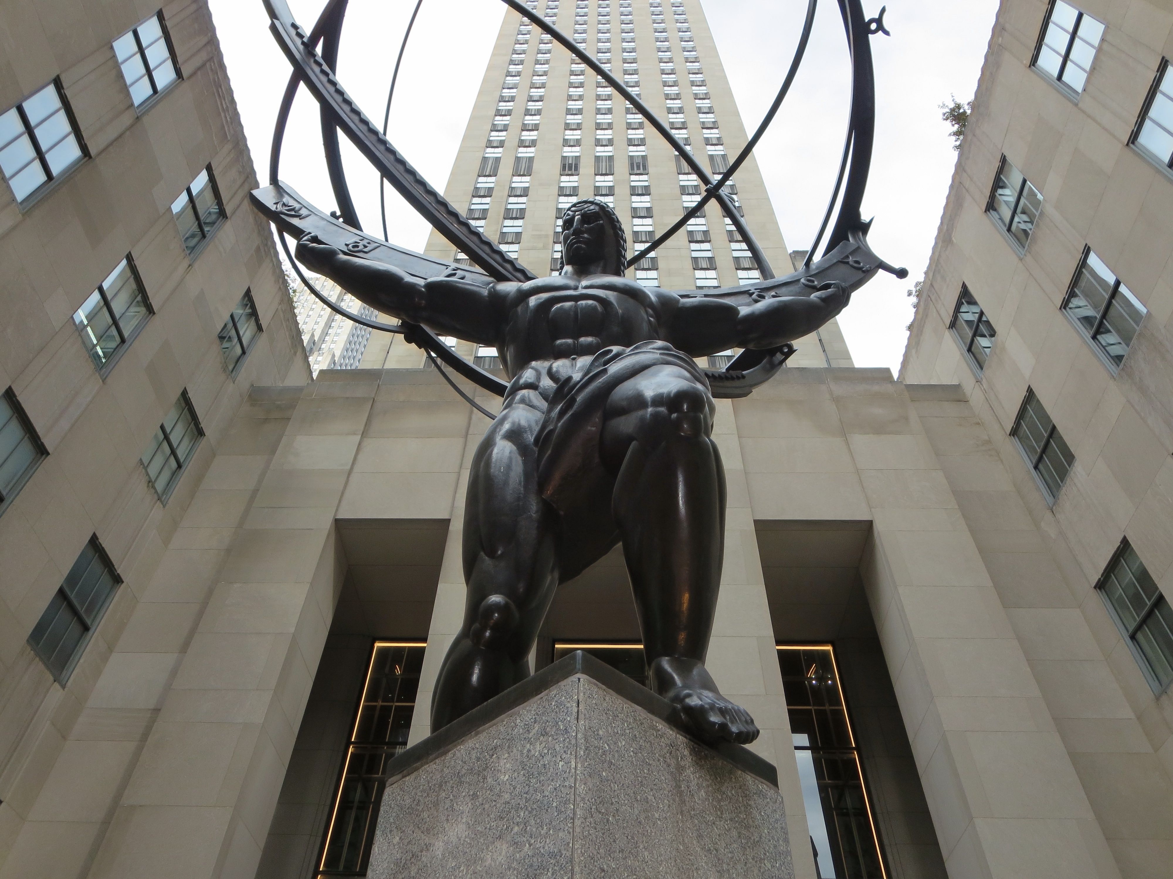 View of the Atlas statue in Rockefeller Center, New York City, showcasing its imposing architectural backdrop.