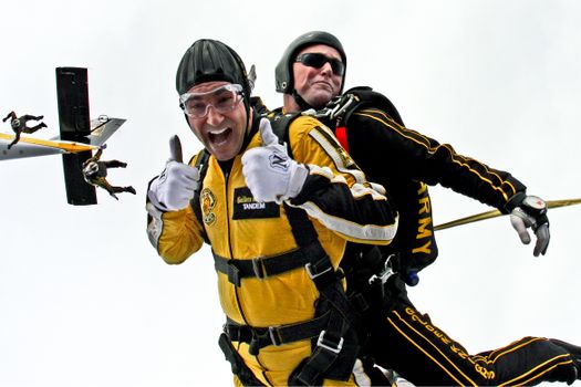 Parachuter in Yellow Suit Doing a Thumbs Up 