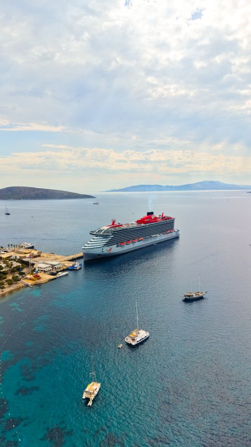 Free Stunning aerial view of a cruise ship docked near the coast of Bodrum, highlighting the serene blue waters of Türkiye. Stock Photo