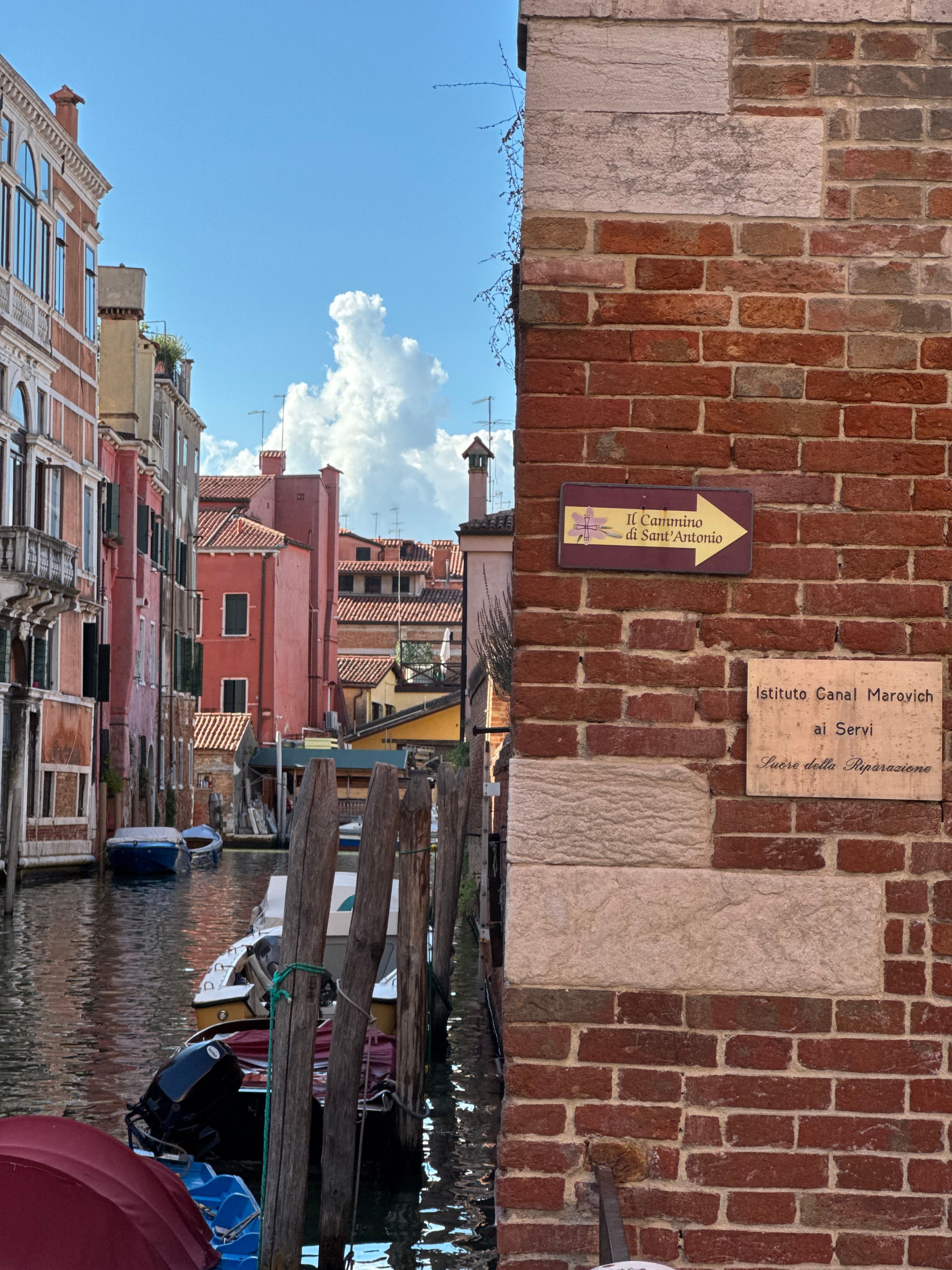 Captivating view of a tranquil canal in Venice, flanked by colorful buildings and classic Venetian architecture.