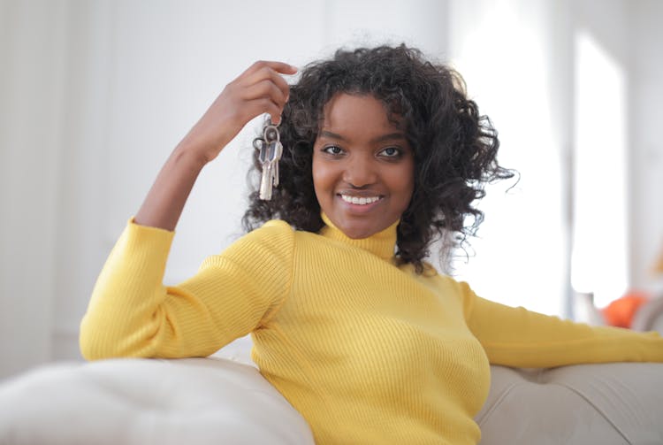 Woman In Yellow Sweater Holding Keys