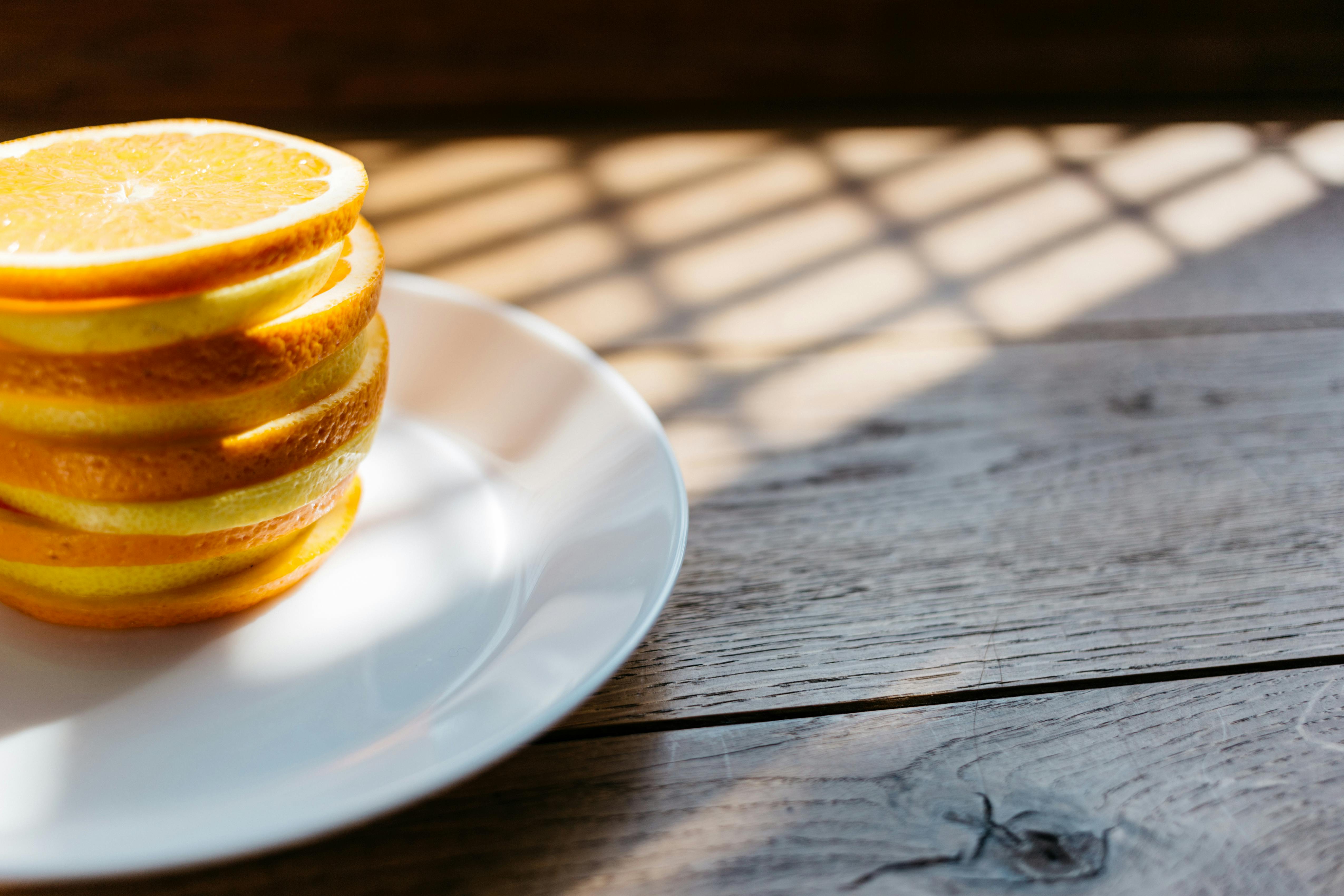 pile of sliced lemon on white plate