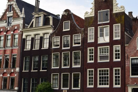 Charming view of historic Dutch architecture with ornate gables in Amsterdam.