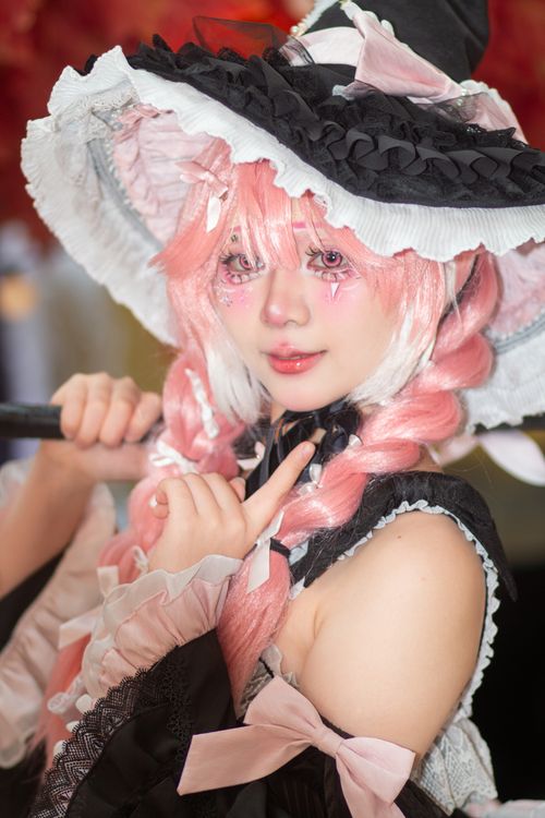 Free A detailed portrait of a pink-haired individual in a witch-themed cosplay costume. Stock Photo
