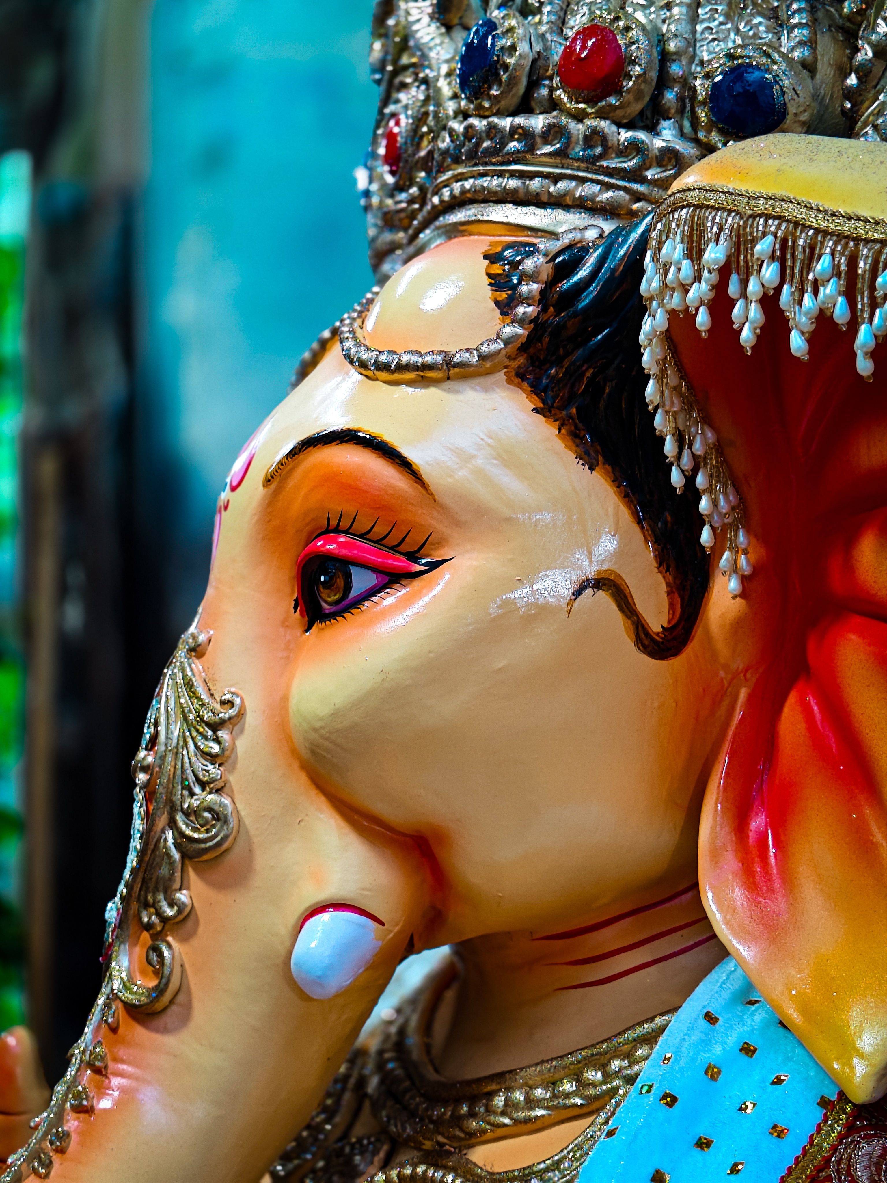 Close-up of a colorful Ganesha statue displaying intricate details and cultural significance.