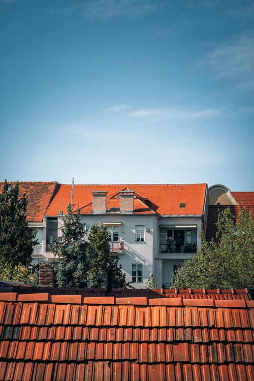 Free Red-roofed building view in Zagreb, Croatia, under a clear blue sky. Stock Photo