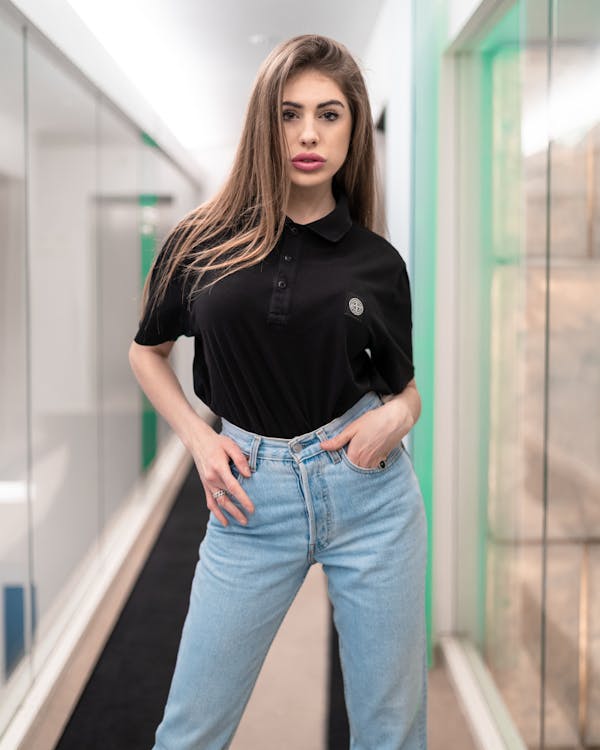 Woman In Black Polo Shirt And Blue Denim Jeans · Free Stock Photo