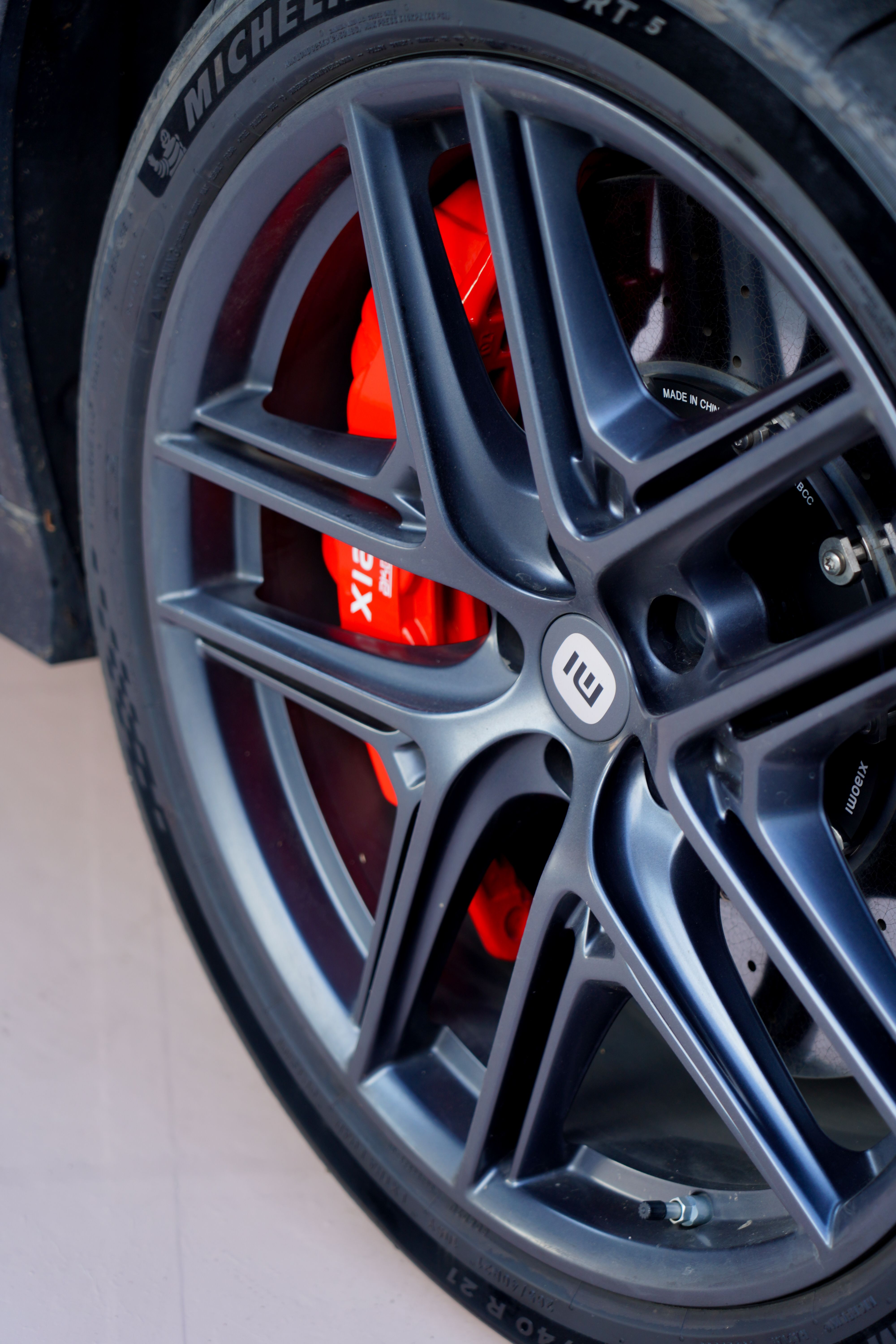 Detailed view of a stylish alloy wheel with a visible red brake caliper.