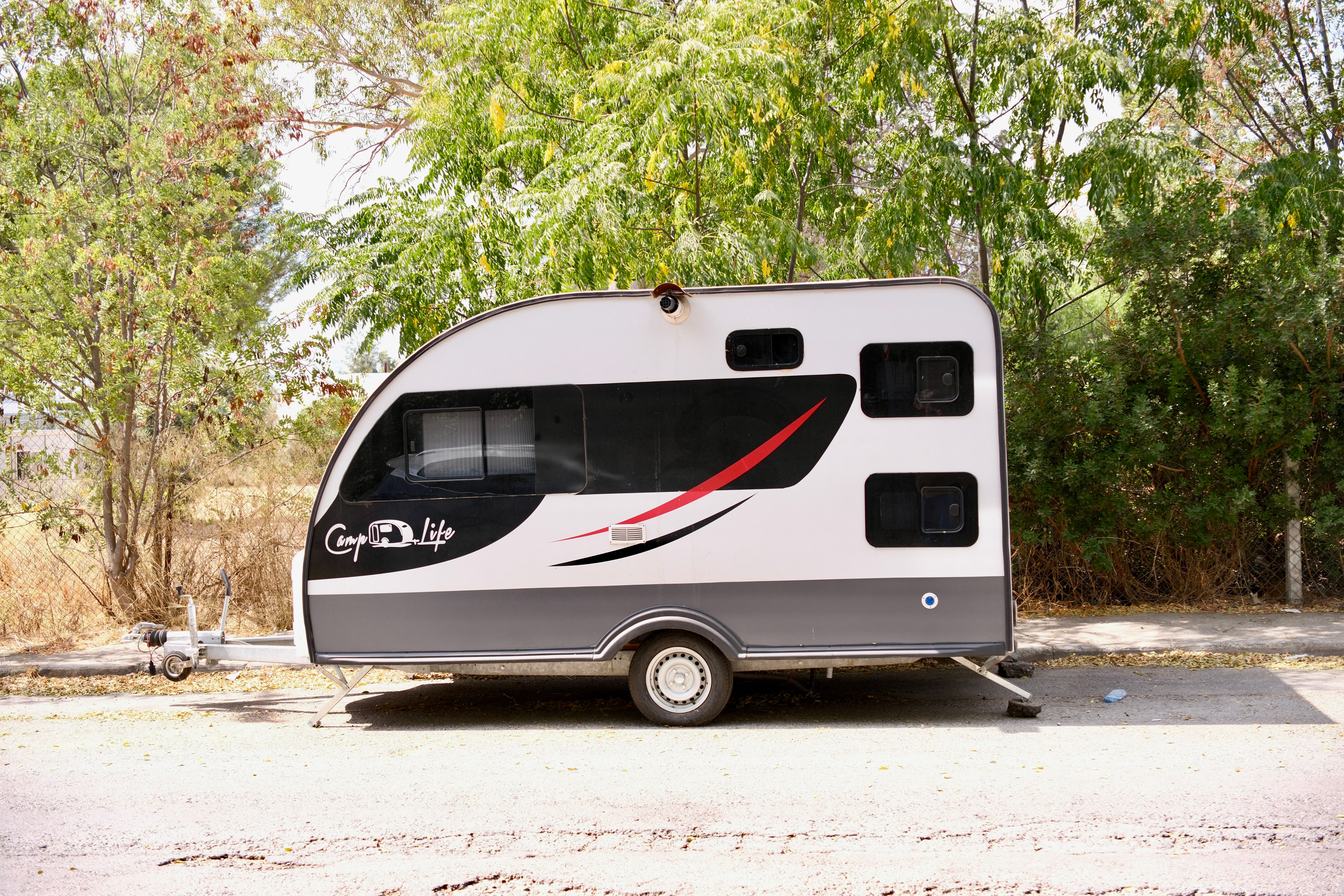 Modern camper trailer parked outdoors, showcased on a sunny day in İzmir, Türkiye.