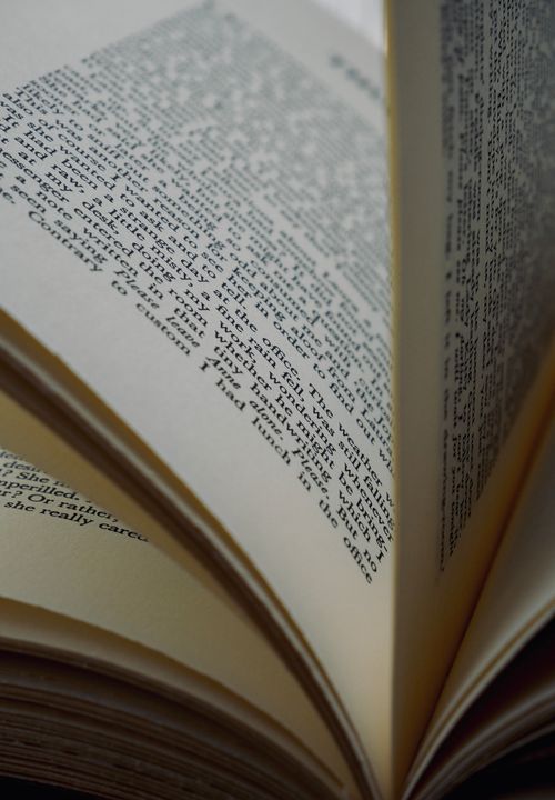 Free Detailed close-up shot of an open book showing text on pages, useful for literary themes. Stock Photo