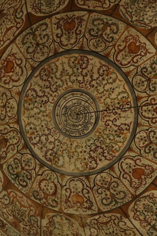 Free Close-up of an ornate dome ceiling featuring Islamic art and floral patterns. Stock Photo