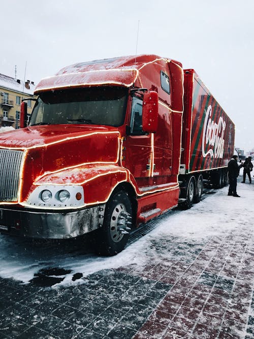 Red Coca-Cola Truck Parked on Snow Covered Road
