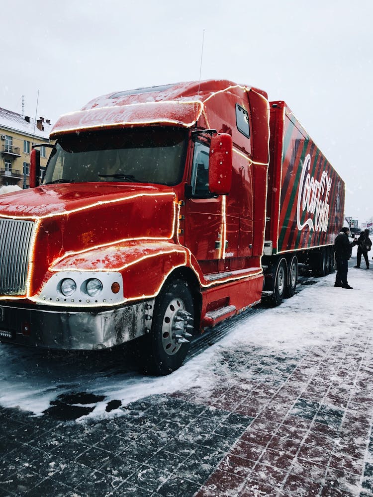 Red Coca-Cola Truck Parked On Snow Covered Road