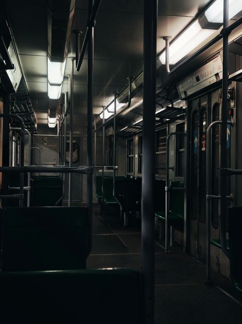 Free Moody interior view of an empty subway train with fluorescent lighting. Stock Photo