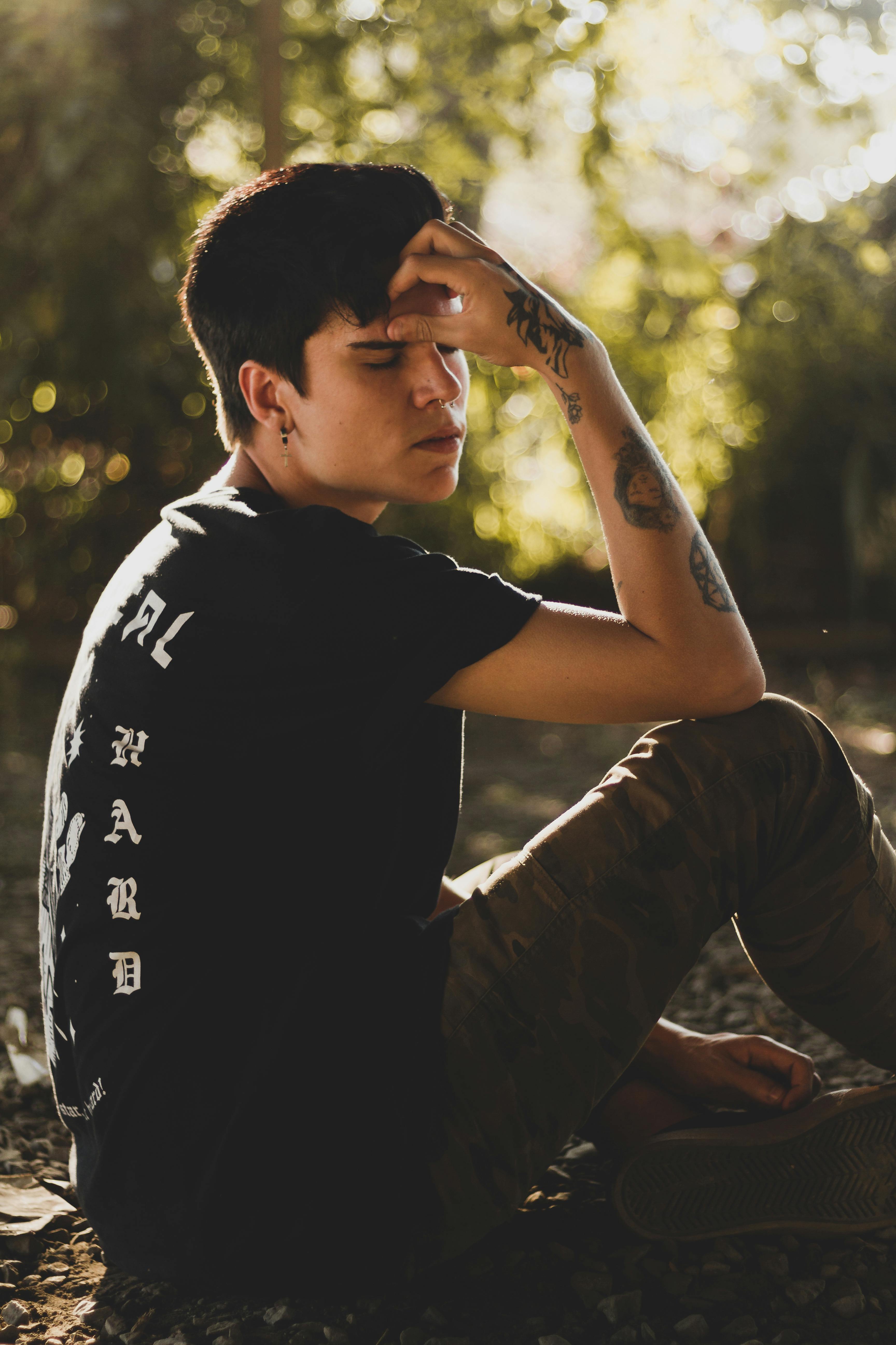 Man in Black Crew Neck T-shirt Sitting on Ground · Free ...