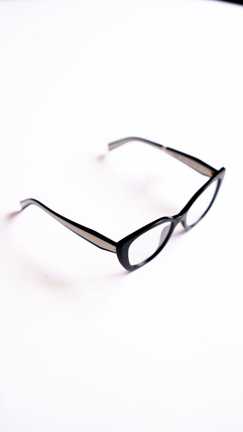 Free Simple and elegant black eyeglasses displayed on a bright white background. Stock Photo