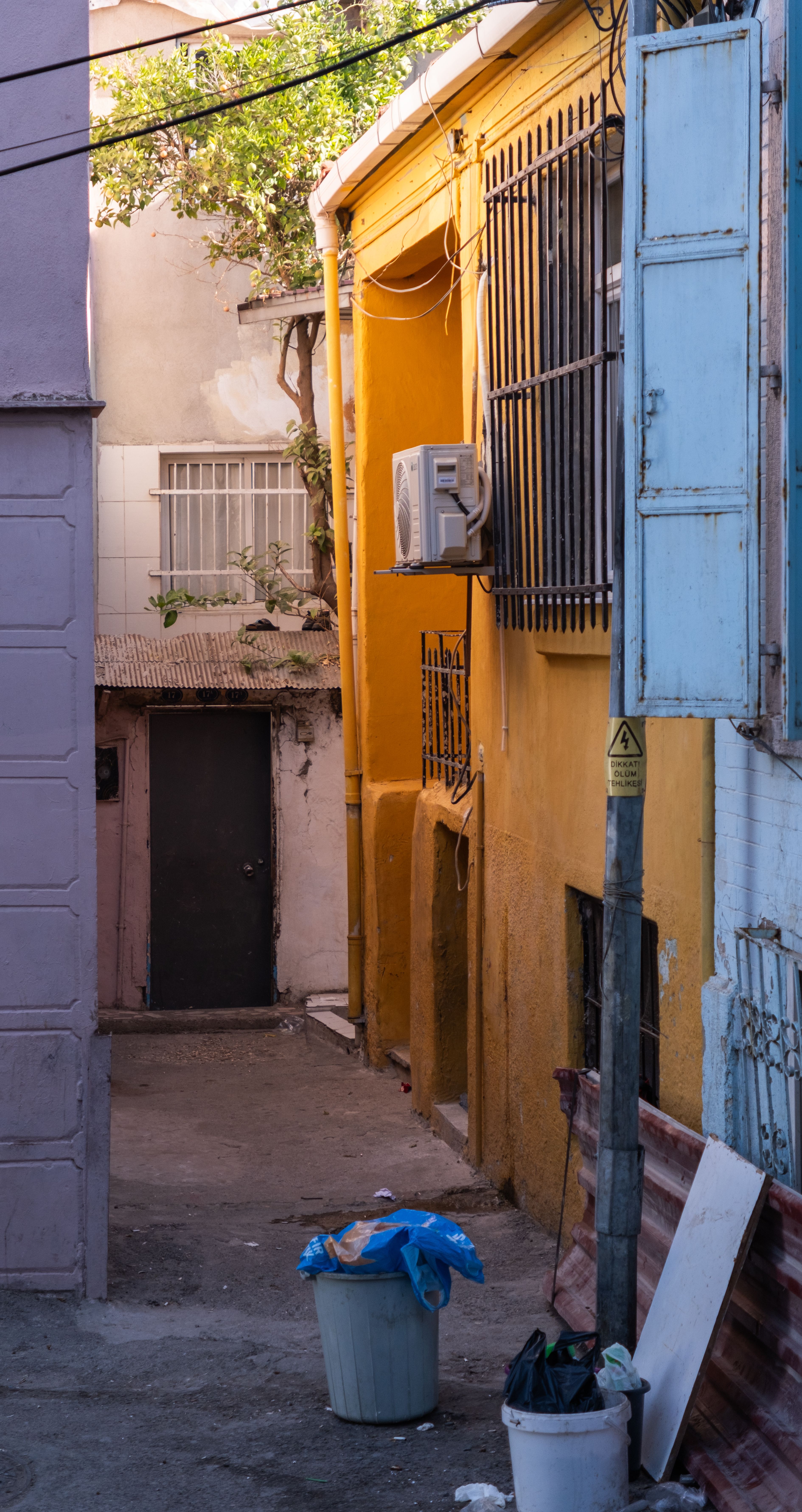 Vibrant alleyway scene in İzmir showcasing colorful architecture and serene urban setting.