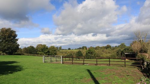 Free Idyllic landscape of a countryside field in Wybunbury, England on a sunny day. Stock Photo