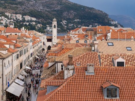 Aerial view of Dubrovnik's iconic red rooftops and historic clock tower in the Old Town, Croatia.