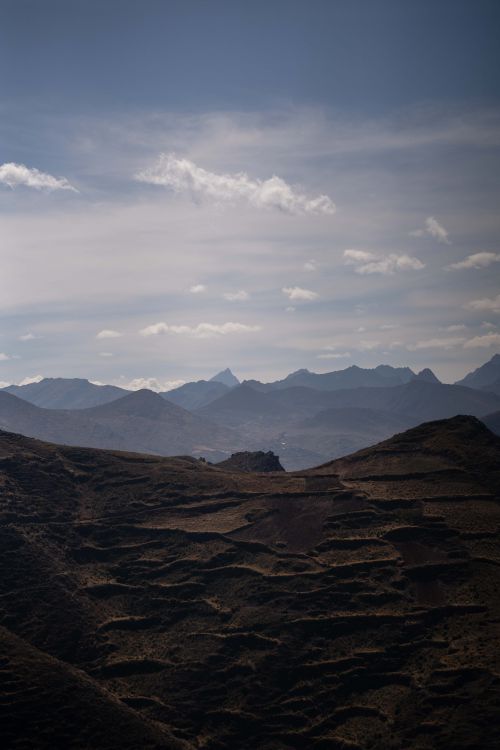 Free Dramatic view of mountain peaks and terraced fields under a clear sky. Stock Photo