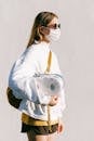Woman in Mask Holding Toilet Paper