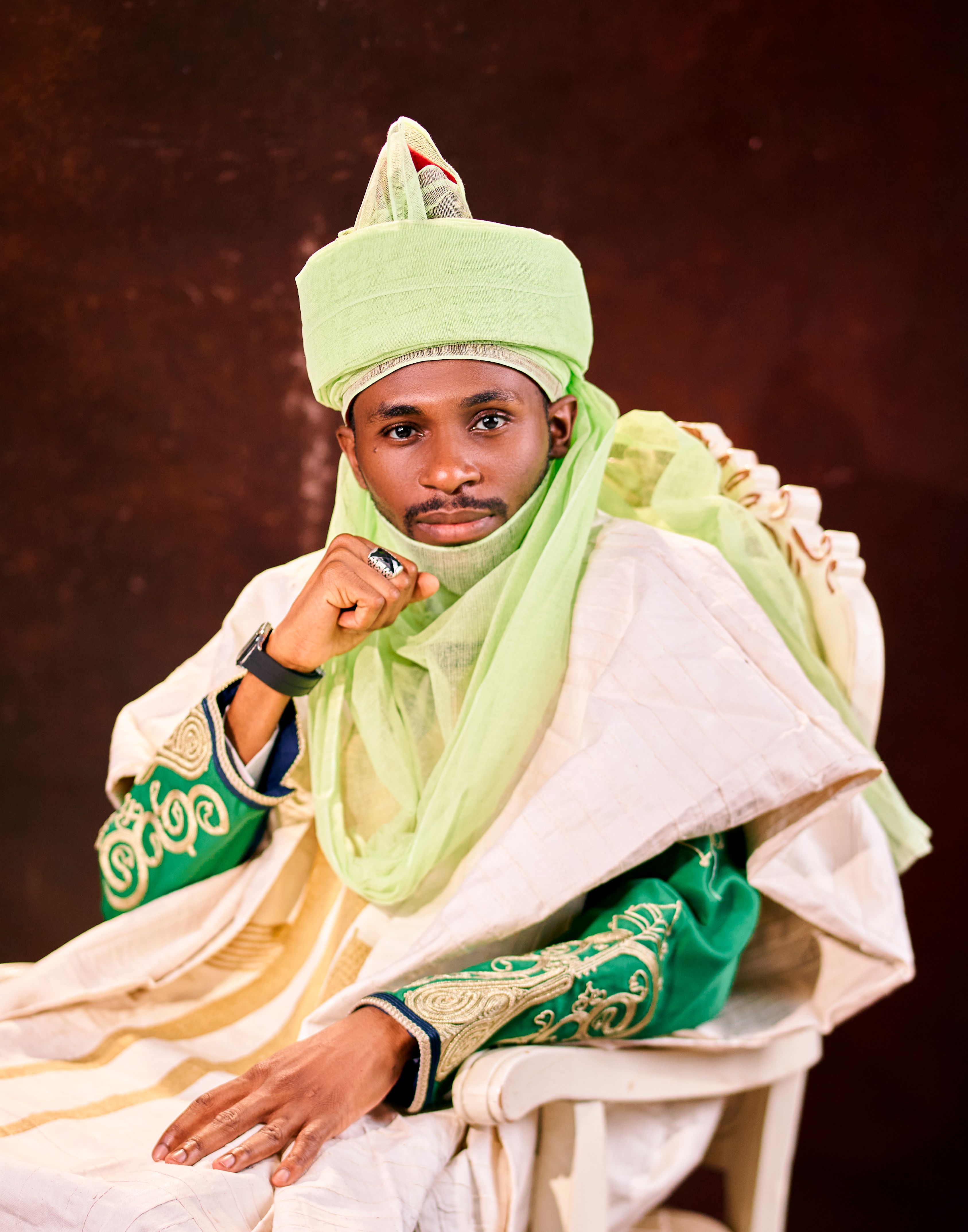 Portrait of a man in vibrant traditional Nigerian attire, highlighting cultural richness.