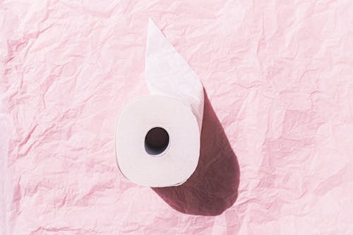 Free White Toilet Paper Roll On Pink Surface Stock Photo