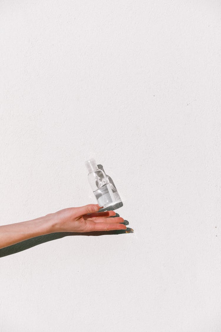 Person Holding Hand Sanitizer