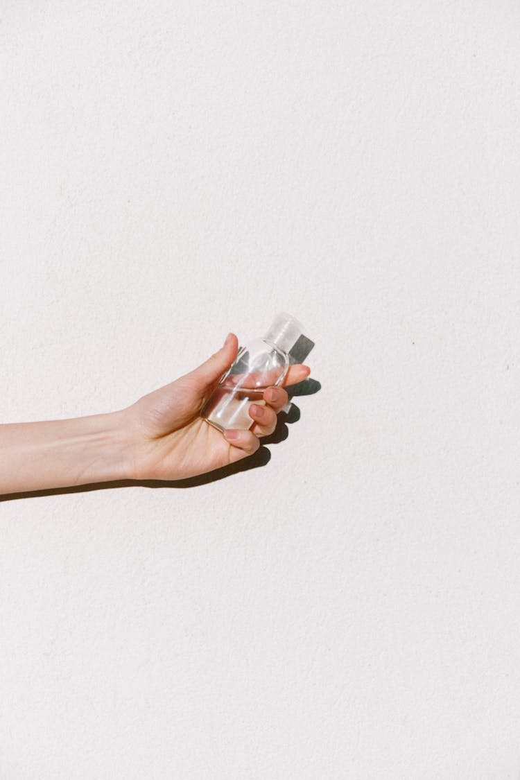 Person Holding Hand Sanitizer