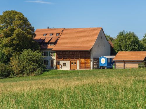 Free Rustic farmhouse under a clear sky in lush countryside. Stock Photo