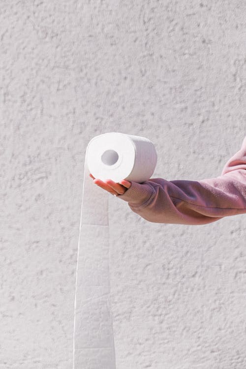 Free Person Holding White Toilet Paper Roll Stock Photo