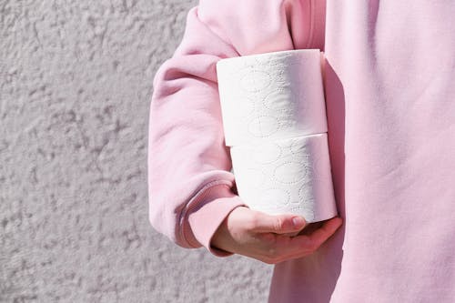 Person In Pink Sweater Holding White Tissue Paper