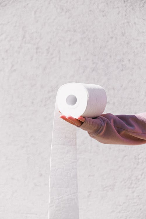 Free Person Holding White Toilet Paper Roll Stock Photo