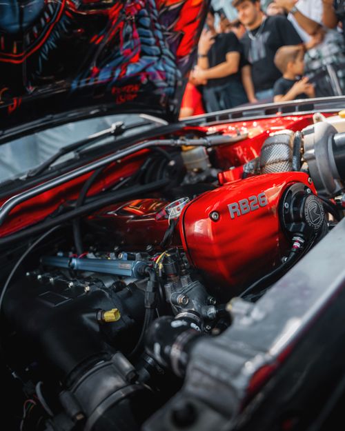 Free Colorful RB26 engine detail at an auto show in Ankara, Türkiye. Vibrant and powerful automotive display. Stock Photo