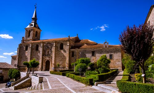 Free Explore the historical San Pedro Collegiate Church under a bright blue Spanish sky in Lerma. Stock Photo