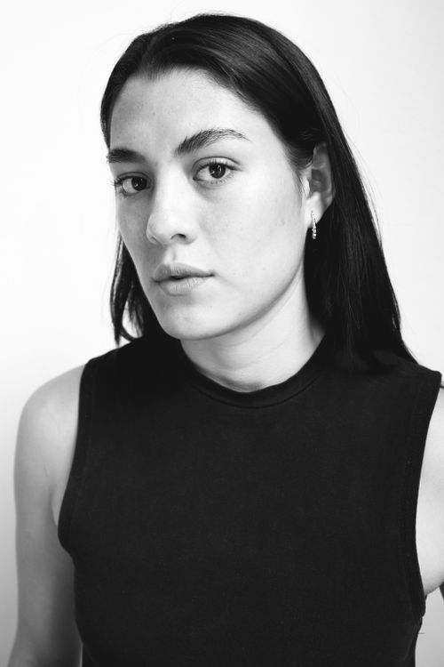 Free Classic black and white portrait of a young woman with a neutral expression. Stock Photo