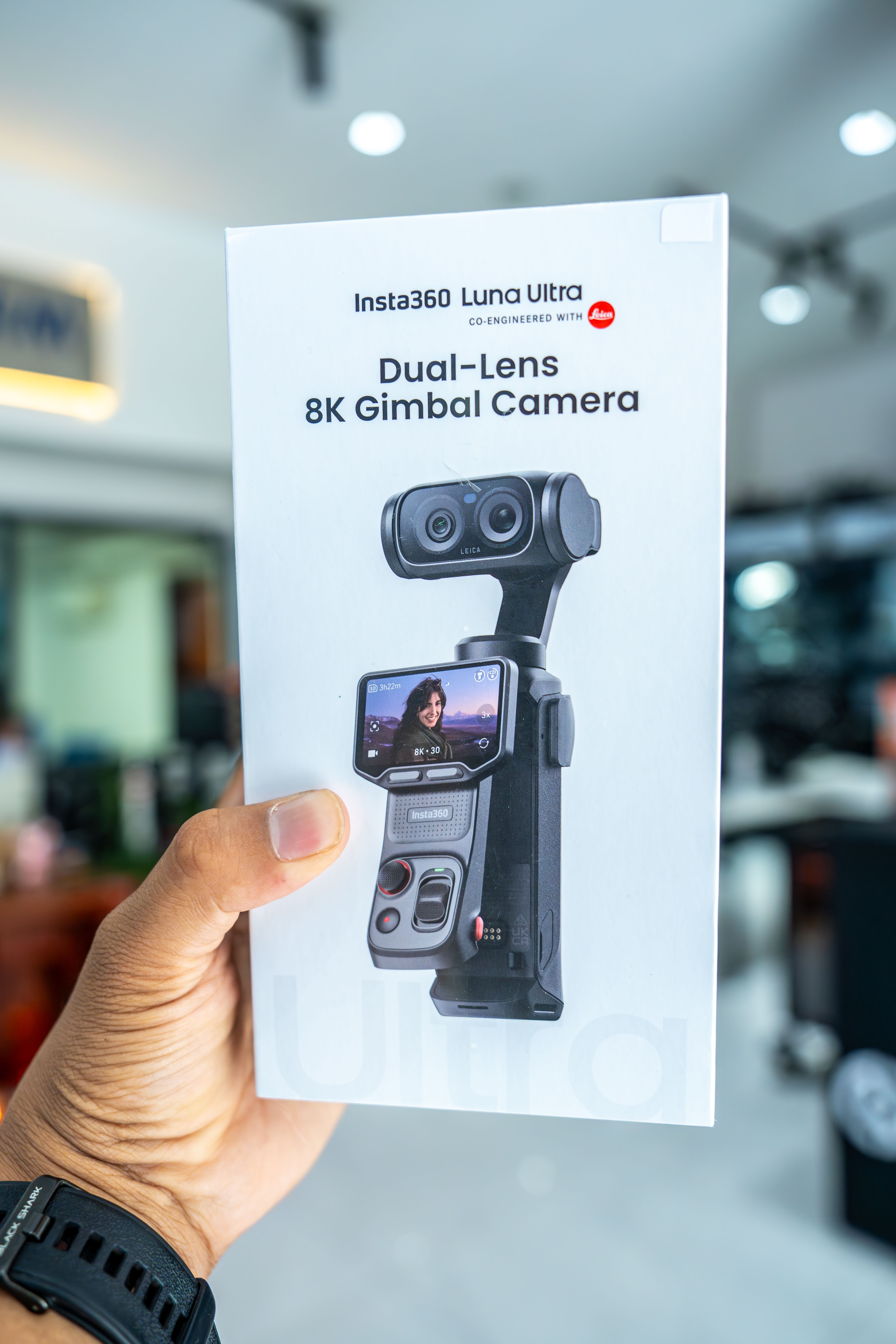 Close-up of Insta360 Luna Ultra 8K Gimbal Camera box held by a hand, highlighting packaging and product image.