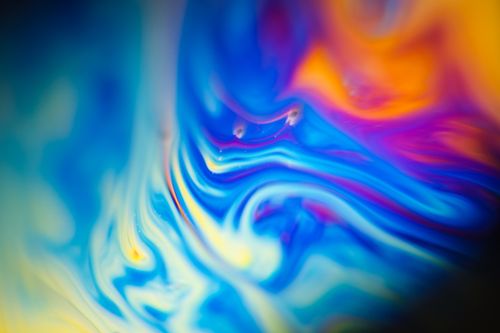 Free A captivating abstract image featuring vivid swirls of blue, orange, and yellow colors. Perfect for artistic and creative uses. Stock Photo