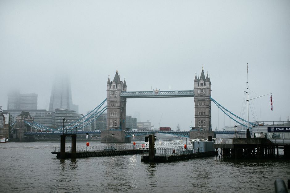 A foggy day capturing London's iconic Tower Bridge over the River Thames.